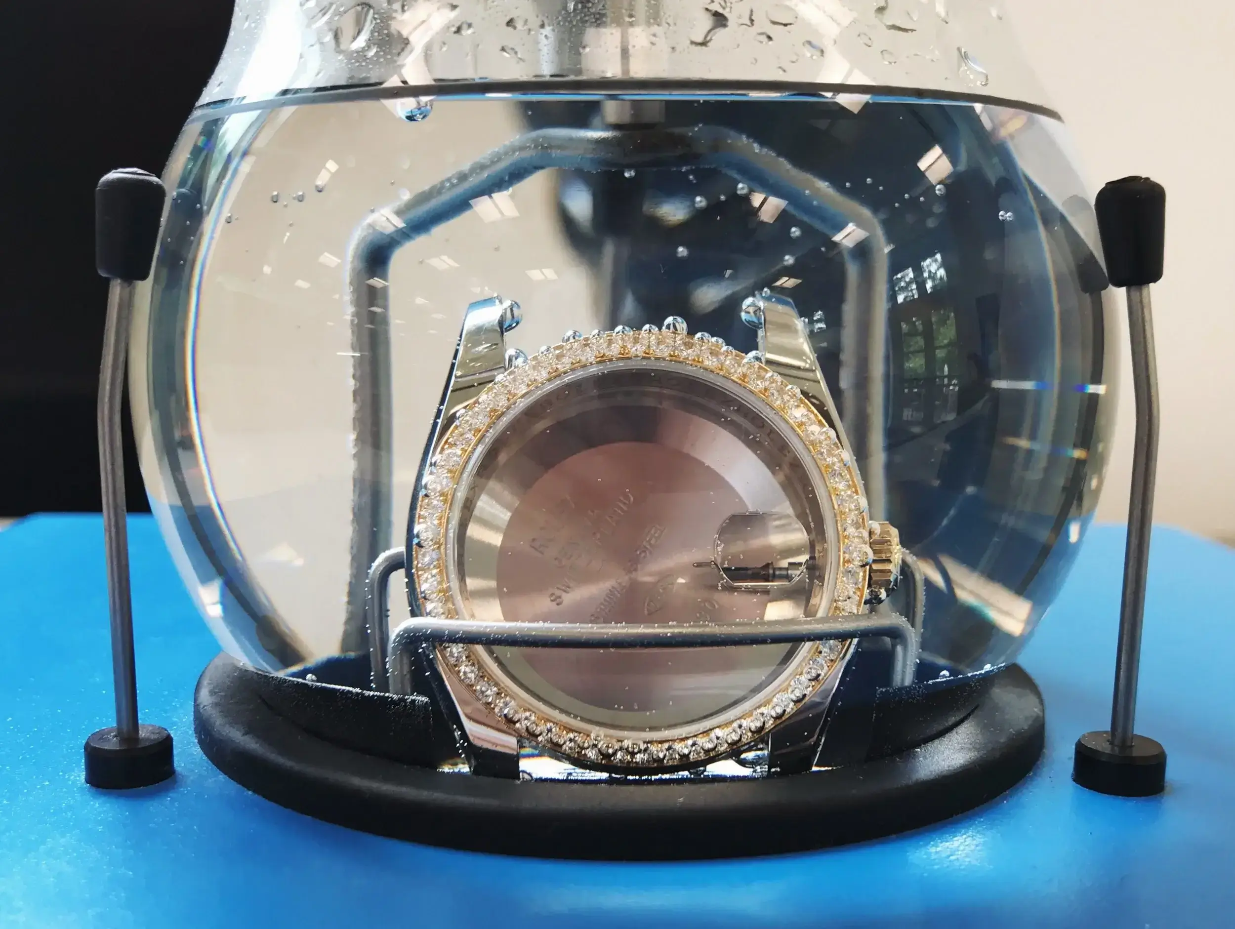 A watch being placed into a pressure testing machine