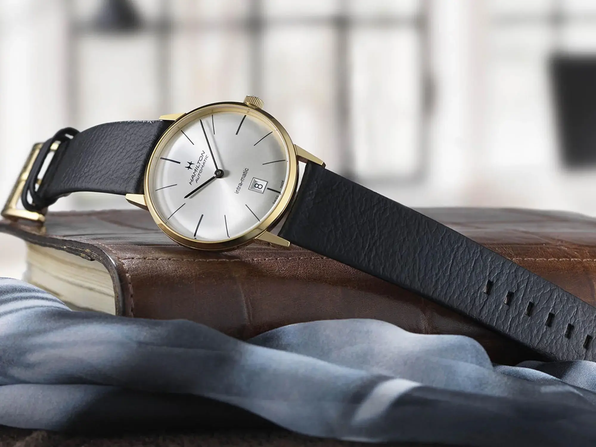 Luxury dress watch with a polished gold case.